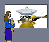 A white woman with long brown hair wearing a blue shirt and skirt and sporting a JPL badge holds an infant as she looks at the wondrous spacecraft Cassini, about to leave for Saturn